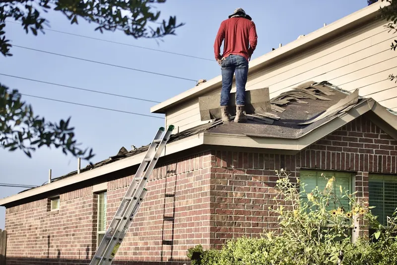 Professional roofer working on a residential roof in Little York